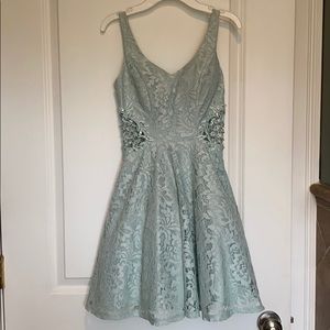 teal lace dress with a small cut out on both sides